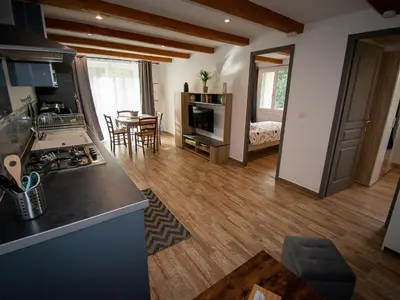 a kitchen and a living room with a table at Apartment Gîte Moulin de Tartay by Interhome in Avignon