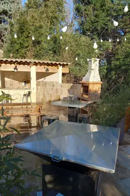 a table with a glass top in a patio at Apartment Gîte Moulin de Tartay by Interhome in Avignon