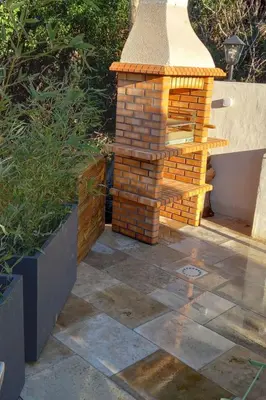 a brick fireplace in a patio with a brick wall at Apartment Gîte Moulin de Tartay by Interhome in Avignon
