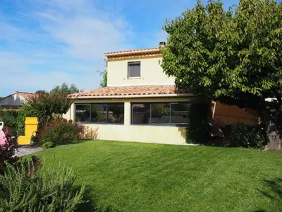 a house with a green lawn in front of it at Holiday Home by Interhome in Vernègues