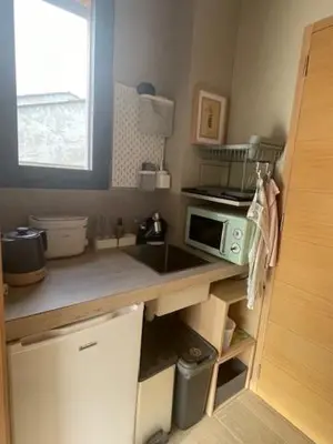 a small kitchen with a sink and a microwave at 1 Brin à part in Maubec