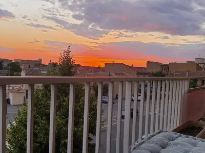 a view of a sunset from a balcony at Appartement Spacieux avec Balcon in Carpentras