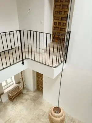 a spiral staircase in a room with a basket at Le Mas des Poètes in Saint-Andiol