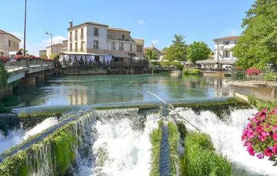 a river with a waterfall in a city at Nice Home In Jonquerettes in Jonquerettes