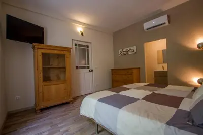 a bedroom with a bed and a flat screen tv at 