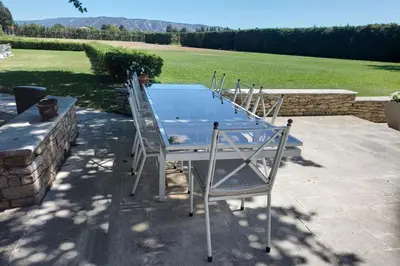 a group of chairs and a table on a patio at Villa Ulysse - Tennis court and private pool in LʼIsle-sur-la-Sorgue