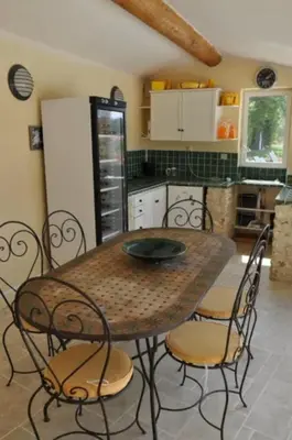 a bedroom with a bed and a bench and a painting at Villa Ulysse - Tennis court and private pool in LʼIsle-sur-la-Sorgue