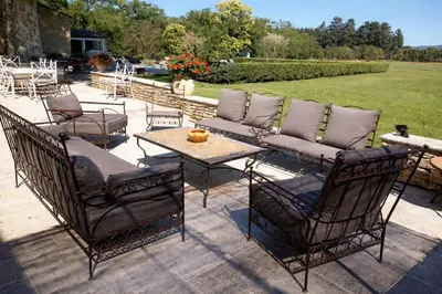 a row of lawn chairs next to a swimming pool at Villa Ulysse - Tennis court and private pool in LʼIsle-sur-la-Sorgue
