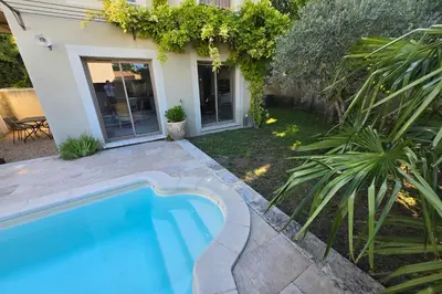 a swimming pool in the backyard of a house at Lou Cabanon in LʼIsle-sur-la-Sorgue