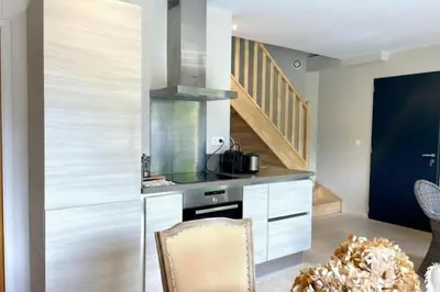 a kitchen with a stove and a staircase at Lou Cabanon in LʼIsle-sur-la-Sorgue