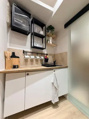a kitchen counter with a wooden counter top at Aix-en-Provence - studio plein centre ville refait à neuf avec climatisation in Aix-en-Provence