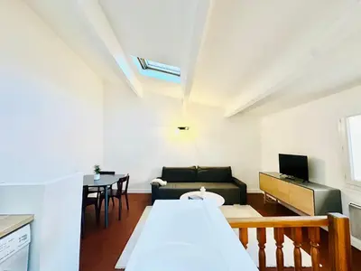 a living room with a couch and a table at Rare duplex with rooftop terrace in Aix-en-Provence