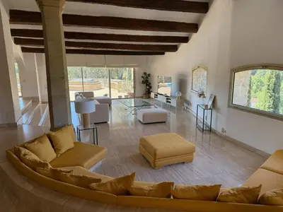 a living room with a couch and a table at Air-conditioned Provençal country house with pool in Jouques