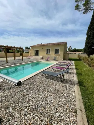 a swimming pool in front of a house at 4-bedroom house with a pool in LʼIsle-sur-la-Sorgue