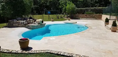 a small swimming pool in a yard with a stone patio at Dépendance de charme avec piscine en luberon in Peypin-dʼAigues