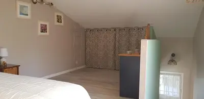 a bedroom with a bed and a dresser and a window at Dépendance de charme avec piscine en luberon in Peypin-dʼAigues