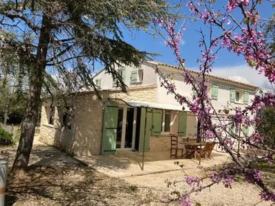 a house with a picnic table in front of it at gite de charme au pied du luberon avec piscine privée à Apt en Provence in Apt