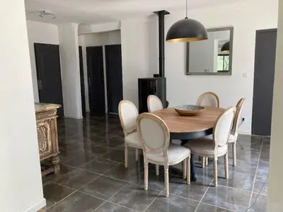 a dining room with a wooden table and chairs at gite de charme au pied du luberon avec piscine privée à Apt en Provence in Apt