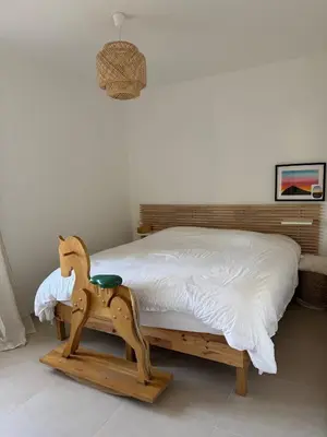 a bedroom with a bed with a wooden horse on it at Ideal Cyclistes Km0 Ventoux RDC cour parking in Bédoin