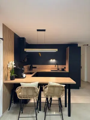 a kitchen with a wooden table and two chairs at Ideal Cyclistes Km0 Ventoux RDC cour parking in Bédoin