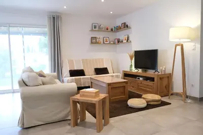 a living room with a couch and a tv at Holiday rental with pool in the Alpilles for 6 people in Plan-dʼOrgon