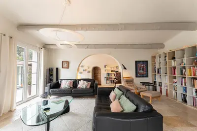 a living room with two couches and a glass table at Aurenza - Piscine - Jardin paysager - Vue campagne in Éguilles