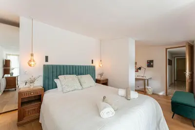 a bedroom with a large white bed with a green headboard at Aurenza - Piscine - Jardin paysager - Vue campagne in Éguilles