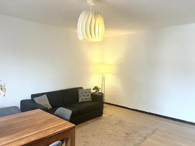 a living room with a couch and a table at Superbe T4 proche Aix centre ville avec clim et parking in Aix-en-Provence