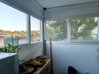 a room with three windows and a bowl of fruit on a table at T2 lumineux balcon, parking facile, climatisation, Wi-Fi in Aix-en-Provence