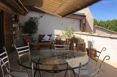 a glass table and chairs on a patio at Grand appartement avec terrasse place Richelme in Aix-en-Provence