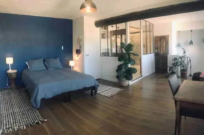 a bedroom with two beds and a blue wall at Grand appartement avec terrasse place Richelme in Aix-en-Provence