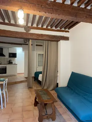 a living room with a blue couch and a table at plaisir de vacances in Aix-en-Provence