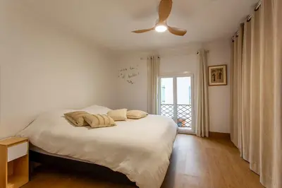 a bedroom with a bed and a ceiling fan at L'Oustaou - Climatisé avec terrasse in Pélissanne