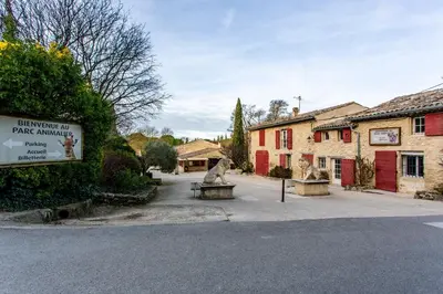 a street in a village with a sign and a building at L'Oustaou - Climatisé avec terrasse in Pélissanne