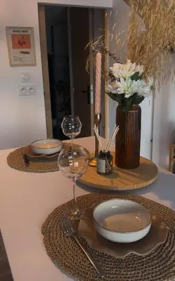a table with two plates and wine glasses on it at COZY LOFT - Maisonnette esprit loft in Saint-Cannat