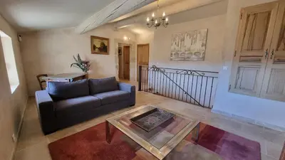 a living room with a couch and a glass table at La Fabrique in Gargas