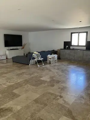 a living room with a couch and a tv at Villa situé à Sainte-Tulle in Sainte-Tulle