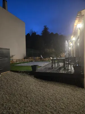 a patio with a table and lights at night at Villa situé à Sainte-Tulle in Sainte-Tulle