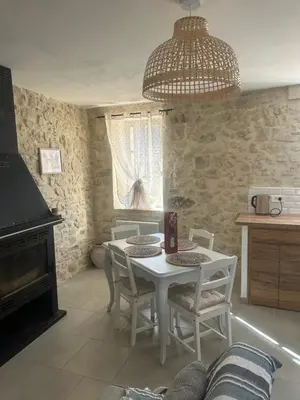 a dining room with a white table and chairs at Jolie maison au coeur du Luberon in Saint-Martin-de-Castillon