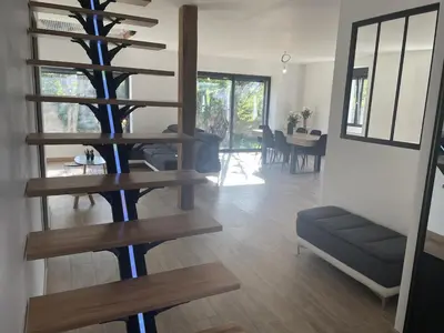 a living room with a spiral staircase in a house at Villa moderne tout confort in Salon-de-Provence