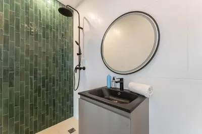 a bathroom with a sink and a mirror at Elynéa - Vue panoramique - Haut standing - Piscine in Rognes