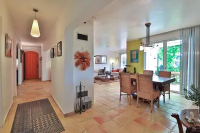 a dining room and living room with a table and chairs at Superbe Villa Piscine Jardin proche Aix in Éguilles