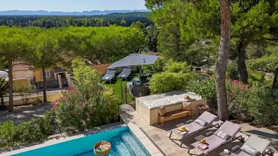 an aerial view of a backyard with a pool and patio furniture at Mas Noves - Horizon Alpilles villa in Noves
