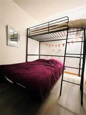 a bedroom with a bunk bed with purple sheets at Appartement Domaine du Golf de Pont Royal in Mallemort