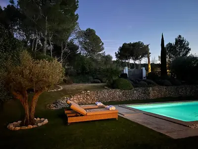 a backyard with a pool and a couch next to a tree at Bastide Lavandin - Stunning Provencal Escape in Ventabren