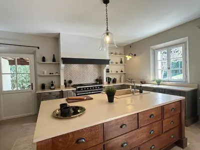 a large kitchen with a large island in the middle at Bastide Lavandin - Stunning Provencal Escape in Ventabren