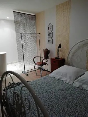 a bedroom with a bed and a chair at Maison individuelle in Morières-lès-Avignon