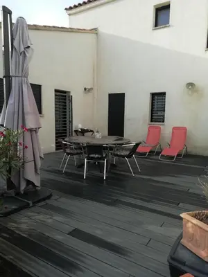 a patio with a table and chairs and a building at Maison individuelle in Morières-lès-Avignon
