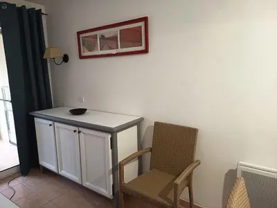 a room with a table and a chair and a picture at Golf de pont royal in Mallemort
