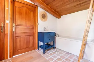 a bathroom with a blue cabinet and a bath tub at Villa confortable avec jardin à Rognes – 200 m² in Rognes